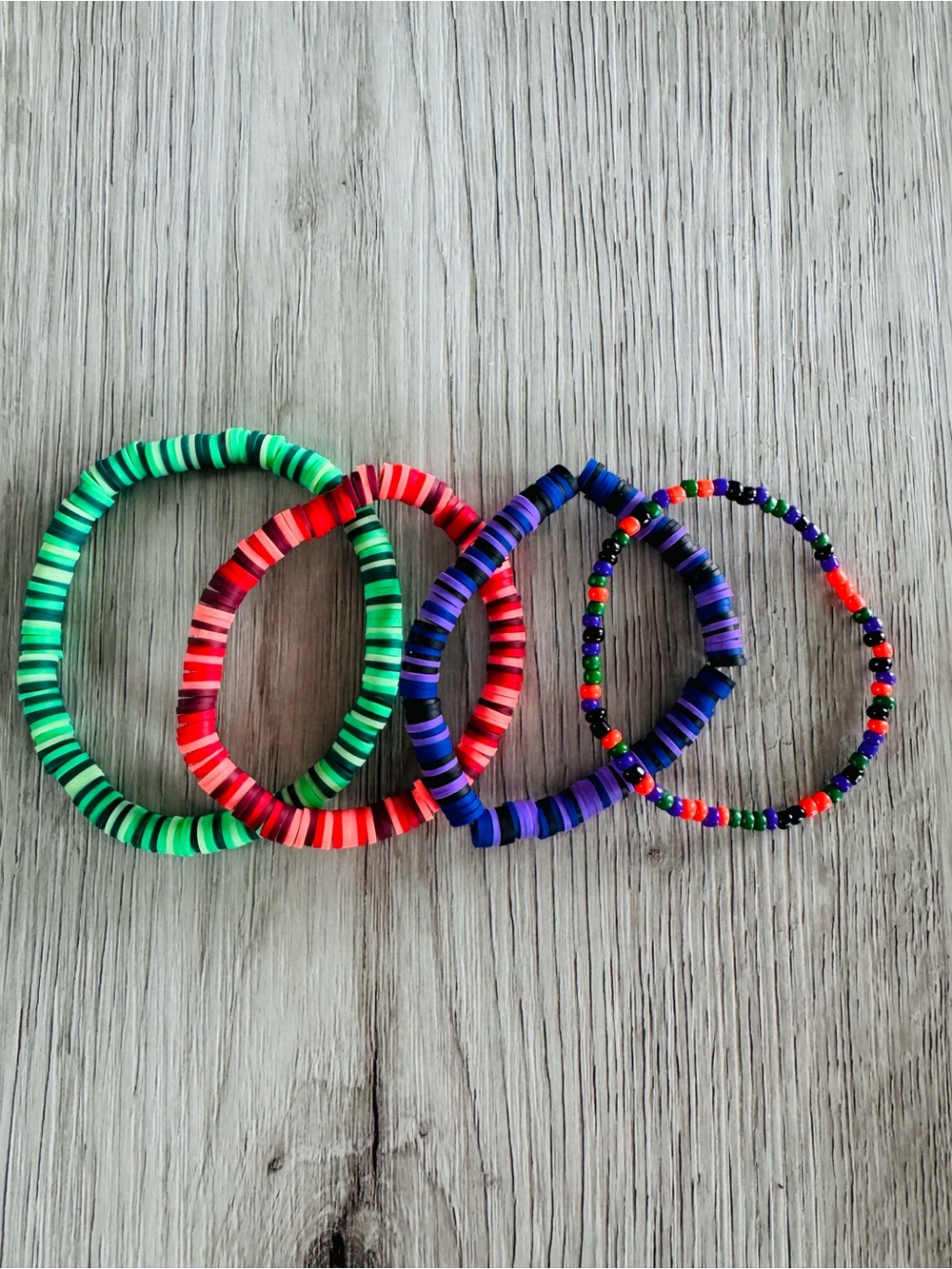 Halloween clay bead & seed bead bracelets in Green, Orange, Purple, and a mix.